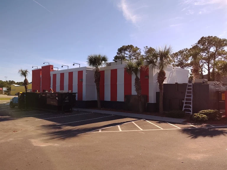 Commercial building pressure washing in progress